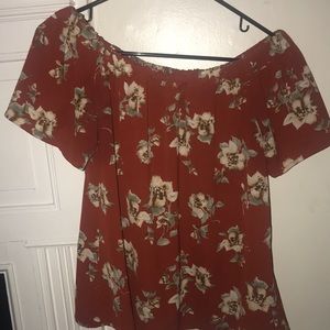 A burnt orange off the shoulder floral top